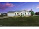 Charming single-story home featuring a well-manicured lawn, an attached garage and an American flag at 182 Jesse Dr, Smithfield, NC 27577
