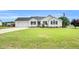 Well-maintained single-story home with an attached garage, blue shutters, and a lush front lawn at 182 Jesse Dr, Smithfield, NC 27577