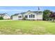 Well-manicured single-story home with attached garage, complemented by a lush front lawn at 182 Jesse Dr, Smithfield, NC 27577
