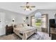 Serene main bedroom featuring a vaulted ceiling, a ceiling fan, and a large window with scenic views at 182 Jesse Dr, Smithfield, NC 27577