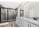 Bathroom features double vanity with granite countertop and sleek glass-enclosed shower with tiled walls at 185 Millwood Dr, Clayton, NC 27527