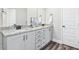 Bathroom boasts double vanity with granite countertop, wood-look flooring, and bright mirrors at 185 Millwood Dr, Clayton, NC 27527