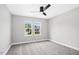 Bedroom boasts two bright windows, carpet flooring, neutral walls, and ceiling fan at 185 Millwood Dr, Clayton, NC 27527