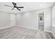 Spacious bedroom features neutral walls and carpet, white trim, ceiling fan, and doorway to closet at 185 Millwood Dr, Clayton, NC 27527