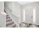 Bright entryway with gray floors, white trim, and natural light from the front door windows at 185 Millwood Dr, Clayton, NC 27527