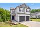 Inviting two-story home with a two-car garage, gray accents, and a neatly maintained lawn and landscaping at 185 Millwood Dr, Clayton, NC 27527