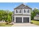 Charming two-story home featuring a two-car garage and a welcoming facade at 185 Millwood Dr, Clayton, NC 27527