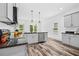 Well-lit kitchen with stainless steel appliances, granite counters and stylish pendant lights at 185 Millwood Dr, Clayton, NC 27527