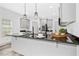 Kitchen island featuring pendant lighting, stainless steel appliances, and neutral cabinets at 185 Millwood Dr, Clayton, NC 27527