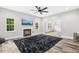 Spacious living room features a fireplace, modern ceiling fan, and hardwood floors at 185 Millwood Dr, Clayton, NC 27527