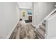 Hallway view into a cozy living room with hardwood floors, a fireplace, and abundant natural light from a window at 185 Millwood Dr, Clayton, NC 27527