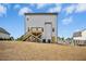 Two-story home with a wooden deck and stairs leading down to the backyard at 185 Millwood Dr, Clayton, NC 27527