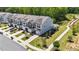 Aerial view showing multiple townhomes with manicured lawns and landscaping at 191 Enterprise Dr, Clayton, NC 27520