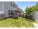 Spacious backyard with green grass, a pergola-covered patio, and well-maintained landscaping at 191 Enterprise Dr, Clayton, NC 27520
