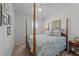 Cozy bedroom featuring a four-poster bed with floral bedding, creating a peaceful and inviting space at 191 Enterprise Dr, Clayton, NC 27520
