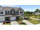 Front exterior showcasing a well-maintained townhome with a two-car garage and lawn at 191 Enterprise Dr, Clayton, NC 27520
