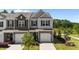 Aerial view of the front of the house featuring a manicured lawn and attached garage at 191 Enterprise Dr, Clayton, NC 27520