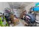 Cluttered garage with visible storage solutions, tools, and workout equipment at 191 Enterprise Dr, Clayton, NC 27520