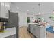 Bright, open kitchen with a large island, stainless steel appliances, and wood flooring at 191 Enterprise Dr, Clayton, NC 27520