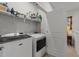 Practical laundry area with modern washer and dryer, shelving for supplies, and easy access at 191 Enterprise Dr, Clayton, NC 27520