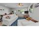 Spacious living room featuring white couches, a ceiling fan, hardwood floors, and natural lighting at 191 Enterprise Dr, Clayton, NC 27520