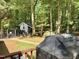 View of the backyard featuring a shed, grill, fenced area, and mature trees offering lots of privacy at 192 Misty Hollow Rd, Timberlake, NC 27583