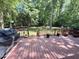 A wooden deck looks out to a lush green backyard at 192 Misty Hollow Rd, Timberlake, NC 27583