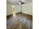 Vacant bedroom featuring luxury vinyl plank flooring, multiple doors, and a ceiling fan with lighting at 192 Misty Hollow Rd, Timberlake, NC 27583
