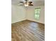 Vacant bedroom featuring luxury vinyl plank flooring, large windows, and a ceiling fan with lighting at 192 Misty Hollow Rd, Timberlake, NC 27583