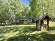 Well house and home set amongst trees and lawn showing the beauty of the property at 192 Misty Hollow Rd, Timberlake, NC 27583