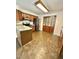 Well-lit kitchen features wood cabinets, stainless steel appliances, and tile flooring at 192 Misty Hollow Rd, Timberlake, NC 27583