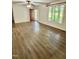 Bright, open living room featuring luxury vinyl plank flooring, an entry door, and a large window at 192 Misty Hollow Rd, Timberlake, NC 27583