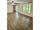 Bright, open living room featuring luxury vinyl plank flooring, large windows, and a ceiling fan at 192 Misty Hollow Rd, Timberlake, NC 27583