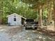 Close-up of a storage shed with a truck parked behind, adding functionality to the property at 192 Misty Hollow Rd, Timberlake, NC 27583