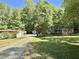 Wide angle view of the front yard and exterior with garage and shed at 192 Misty Hollow Rd, Timberlake, NC 27583