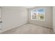 Bright bedroom with plush carpet and a window that lets in plenty of natural light at 201 Mayfield Dr, Apex, NC 27539