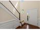 Bright foyer with hardwood floors, staircase, and decorative trim, showcasing an inviting entry at 201 Mayfield Dr, Apex, NC 27539