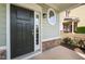 Charming front door with sidelight and transom, complemented by stone accents at 201 Mayfield Dr, Apex, NC 27539