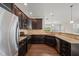 Well-equipped kitchen with granite countertops, stainless steel appliances, and dark wood cabinetry at 201 Mayfield Dr, Apex, NC 27539
