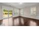 Bright and airy living room with wood floors and sliding door to the patio at 201 Mayfield Dr, Apex, NC 27539