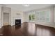 Cozy living room features a fireplace and sliding glass doors leading to the backyard at 201 Mayfield Dr, Apex, NC 27539