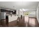 Open-concept living space with hardwood floors, fireplace, and seamless flow to the kitchen at 201 Mayfield Dr, Apex, NC 27539
