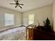 Bedroom featuring a ceiling fan, neutral walls, and two windows providing natural light at 211 Webb St, Roxboro, NC 27573