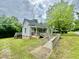 Charming home with a welcoming ramp and lush greenery at 211 Webb St, Roxboro, NC 27573