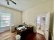 Office featuring a desk and view of a bathroom, with neutral walls and drop ceiling at 211 Webb St, Roxboro, NC 27573