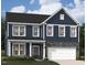 Charming two-story home with blue siding, stone accents, and white trim details at 215 Macon Lake Drive # 23, Apex, NC 27523