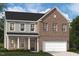 Charming two-story home featuring brick and siding accents, plus an attached two car garage at 223 Macon Lake Drive # 25, Apex, NC 27523