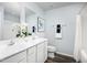 Bright bathroom featuring a double vanity, decorative mirror, and a shower with a white curtain at 248 Elyse Overlook Loop, Sanford, NC 27332