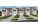 Charming townhomes featuring stone accents, private garages, and manicured landscaping offer an inviting curb appeal at 250 Elyse Overlook Loop, Sanford, NC 27332