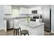 Modern kitchen featuring granite countertops, stainless steel appliances, white cabinets, and an island with seating at 250 Elyse Overlook Loop, Sanford, NC 27332